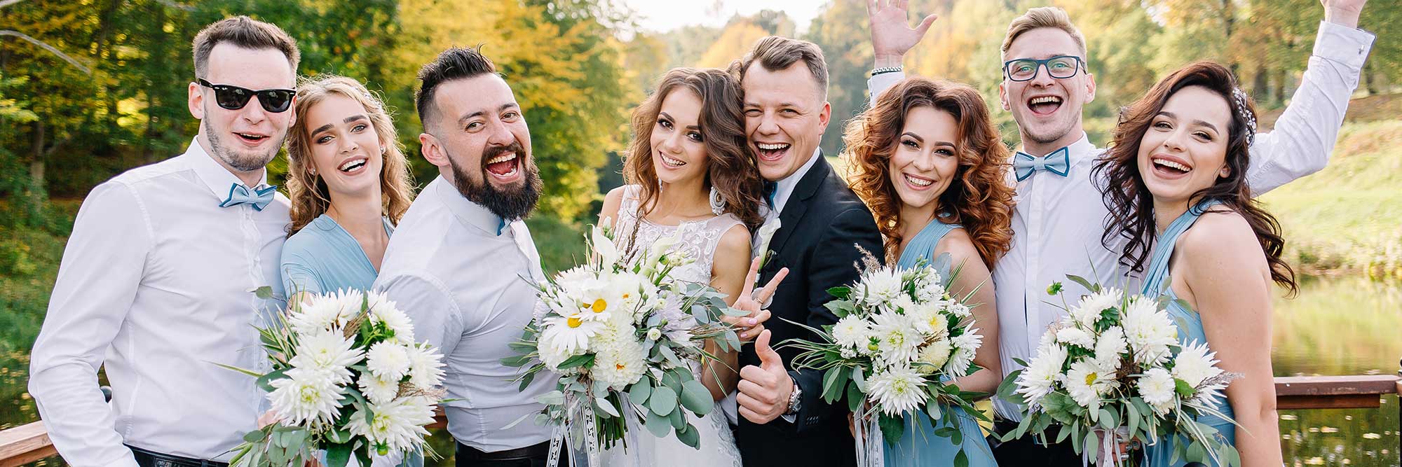 Bridal party taking pictures in front of a lake